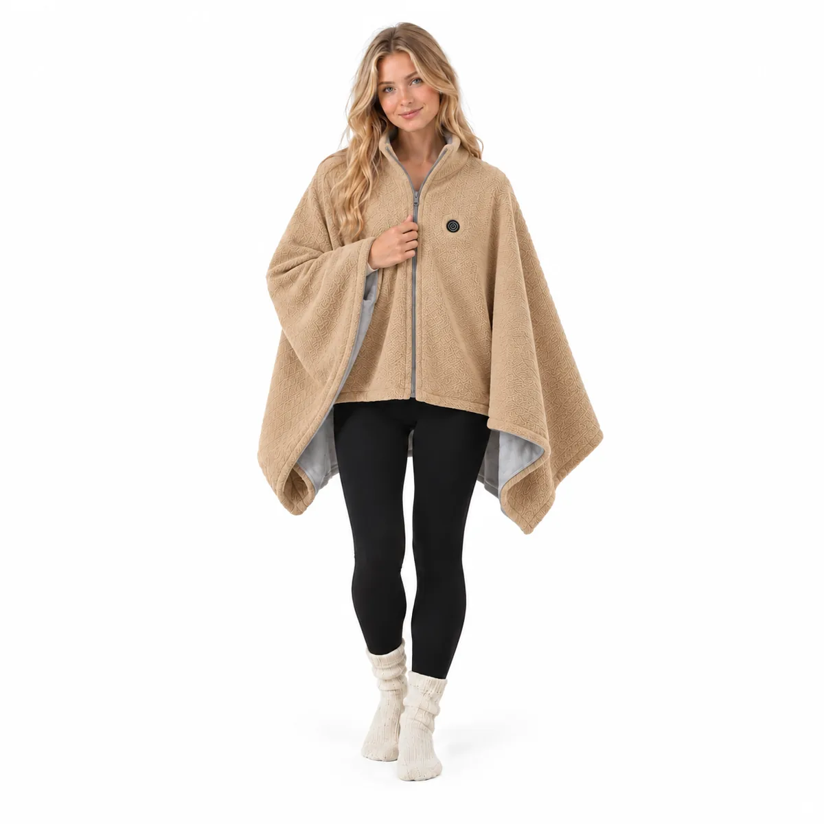 Full-length view of the Snugglfit heated shawl in camel, worn zipped with the power button on the chest